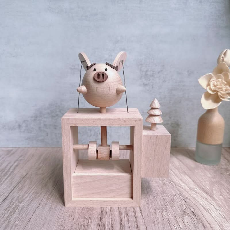 Handcrafted Wooden Flying Pig Toy with Driving Mechanism.